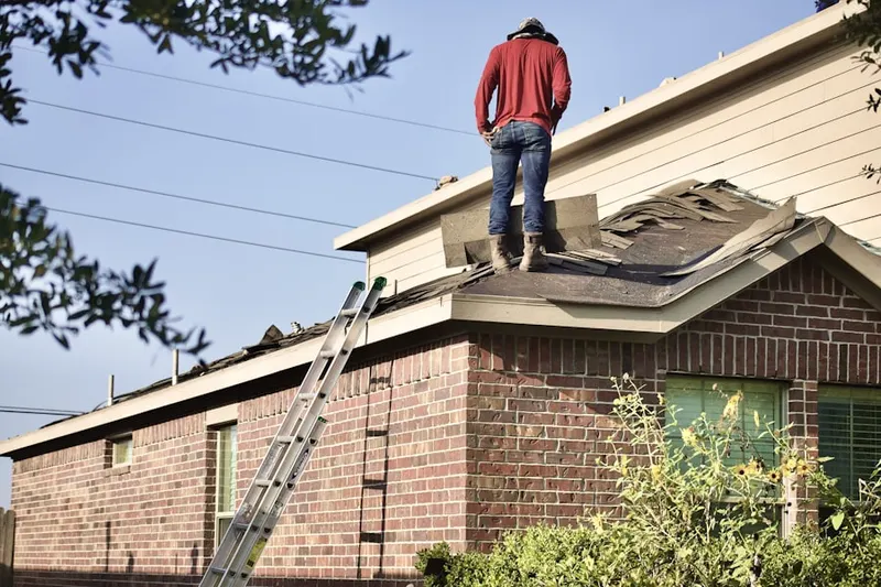 Professional roofer working on a residential roof in Fogartyville